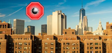 New York City, USA. Concept image with large red coronavirus warning sign in front of Manhattan skyline, travel restriction concept, covid-19 virus outbreak.の写真素材