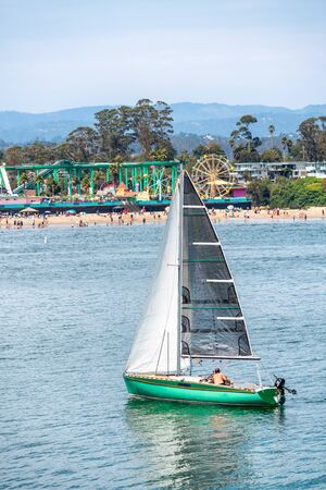 Sailing boat along the beach of Santa Cruz, California.の写真素材