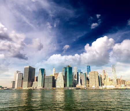 Lower Manhattan buildings and East River reflections on a sunny day, New York City, USAの写真素材