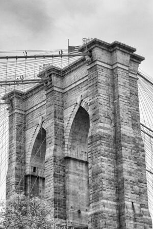 Black and white upward image of the Brooklyn Bridge in New Yorkの写真素材