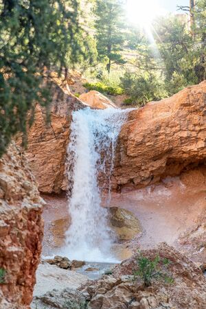 Beautiful waterfalls in the national park at sunset. Water flowing over the orange rocks.の写真素材