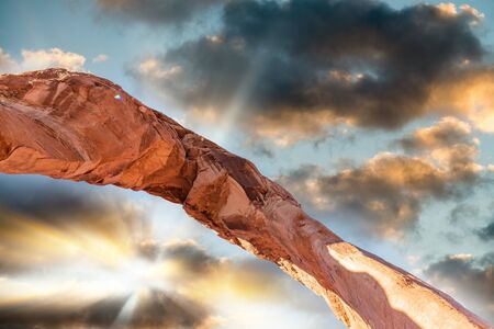 Skyward view of Delicate Arch, Arches National Park. Rock formation and blue sky, USA