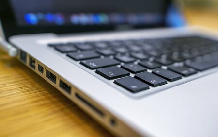 Technology concept. Side view of modern laptop. Keyboard and part of the screen.の写真素材