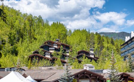 Wooden homes and forest in Vail, Colorado. Summer season with blue sky.の写真素材
