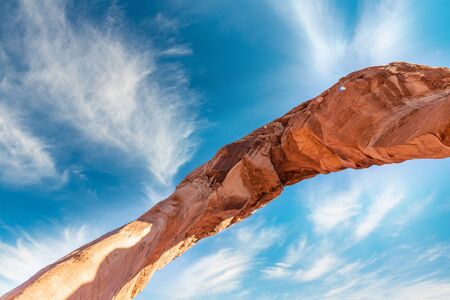 Skyward view of Delicate Arch, Arches National Park. Rock formation and blue sky, USAの写真素材