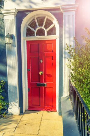 A vivid red ornately decorated door and doorway in London, UK. Notting Hill area.の写真素材