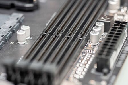 Closeup on empty RAM slots on a modern black silver motherboard. Random access memory stick slots. Macro of electronics and technology, simple pc components, shallow dof.の写真素材
