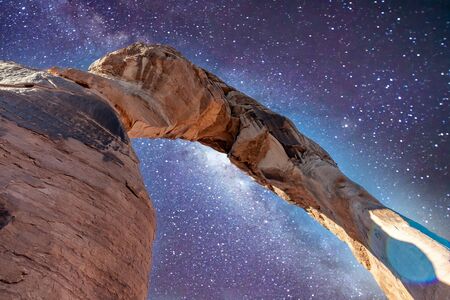 Skyward view of Delicate Arch, Arches National Park. Rock formation and blue sky, USAの写真素材