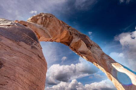 Skyward view of Delicate Arch, Arches National Park. Rock formation and blue sky, USAの写真素材