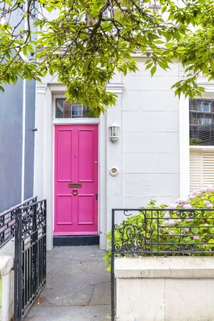 A vivid pink ornately decorated door and doorway in London, UK. Notting Hill area.の写真素材