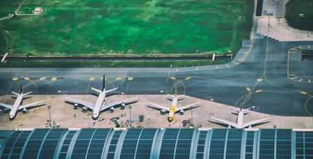 Aerial view of multiple docked airplanes on the airport gate.の写真素材