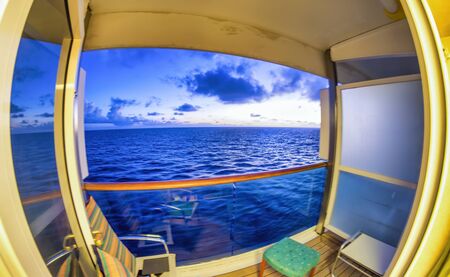 Ocean view from a cruise ship room balcony at sunset. Vacation and relax concept.の写真素材
