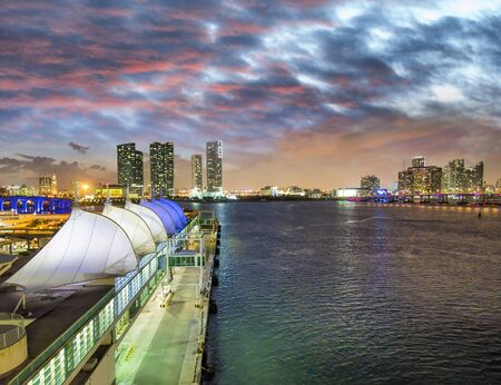 Sunset in Miami Port, Florida. View of the city from departing cruise ship.の写真素材