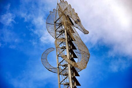 Giant seahorse sign against blue sky.の写真素材