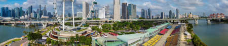 Panoramic aerial view of Singapore skyline from a drone point of view at dusk.のeditorial素材