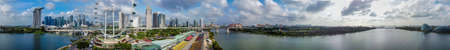 Panoramic aerial view of Singapore skyline from a drone point of view at dusk.のeditorial素材