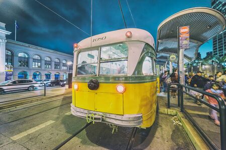 SAN FRANCISCO, CA - AUGUST 7, 2017: Yellow tram at night in Embarcadero area.の写真素材