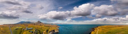 Arnarstapi coastline in sumemr season, Snaefellsnes peninsula, Iceland. Panoramic aerial view from drone at sunset.の写真素材