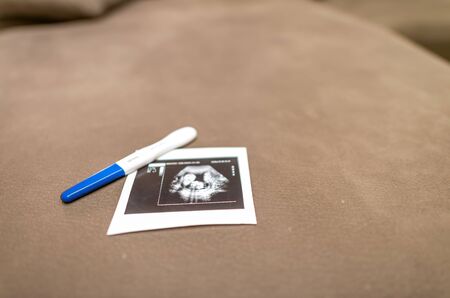 Pregnancy thermometer stick and fetus ultrasound at home.の写真素材
