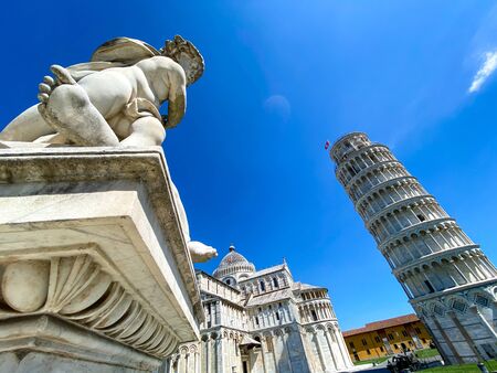 Cherub statue that sits on the Field of Miracles in Pisa, Tuscany.Famous leaning tower in the background.の写真素材