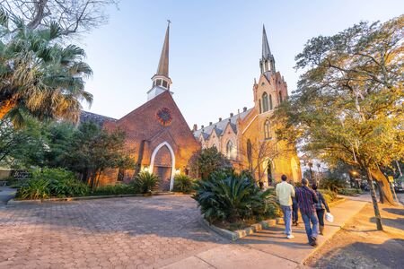 Tourists walking along the street in front of Methodist Church at night, New Orleans.の写真素材