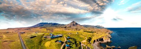 Arnarstapi coastline in sumemr season, Snaefellsnes peninsula, Iceland. Panoramic aerial view from drone at sunset.の写真素材