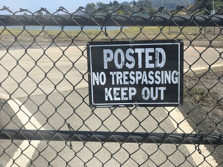 No Trespassing Keep Out sign along the fence.の写真素材