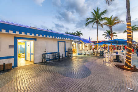 FORT MYERS, FLORIDA - FEBRUARY 2016: Tourists enjoy city promenade at night.のeditorial素材