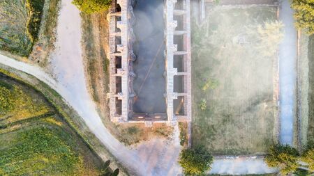 Amazing aerial view of beautiful San Galgano Abbey with roofless walls, Tuscany Hills in spring season, Italy.の写真素材