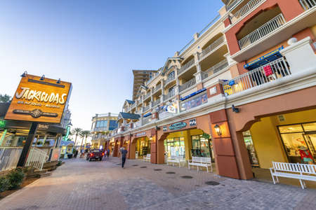DESTIN, FLORIDA - FEBRUARY 2016: Destin Harbor Boardwalk at sunset with shops.のeditorial素材