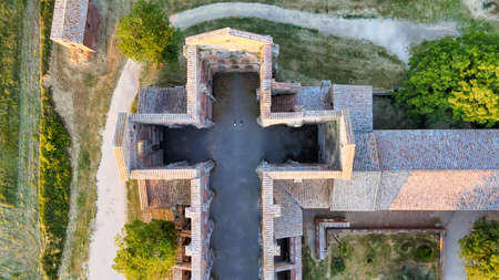 Amazing aerial view of beautiful San Galgano Abbey with roofless walls, Tuscany Hills in spring season, Italy.のeditorial素材