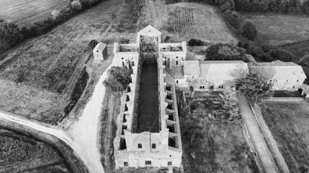 Amazing aerial view of beautiful San Galgano Abbey with roofless walls, Tuscany Hills in spring season, Italy.のeditorial素材