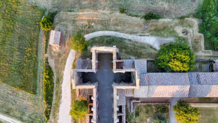 Amazing aerial view of beautiful San Galgano Abbey with roofless walls, Tuscany Hills in spring season, Italy.のeditorial素材