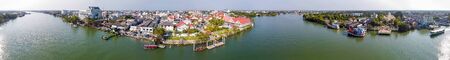 Maeklong, Thailand. Famous railway market and city skyline from city river, panoramic aerial view.の写真素材