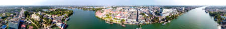 MAEKLONG, THAILAND - DECEMBER 15, 2019: Panoramic aerial view of famous railway market and city skyline from the river.のeditorial素材