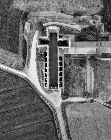 Amazing aerial view of beautiful San Galgano Abbey with roofless walls, Tuscany Hills in spring season, Italy.のeditorial素材