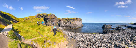 ARNARSTAPI, ICELAND - AUGUST 9, 2019: Tourists visit the Snaefellsnes coastline in summer season.のeditorial素材