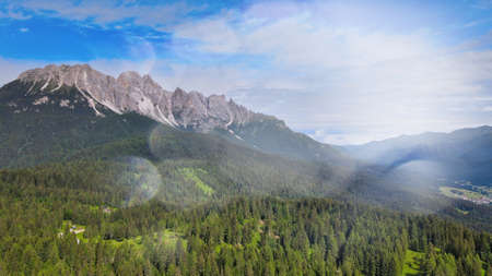 Alpin lake in summer time surrounded by beautiful forest, overhead downward aerial view.の写真素材