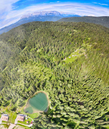 Alpin lake in summer time surrounded by beautiful forest, overhead downward aerial view.の写真素材