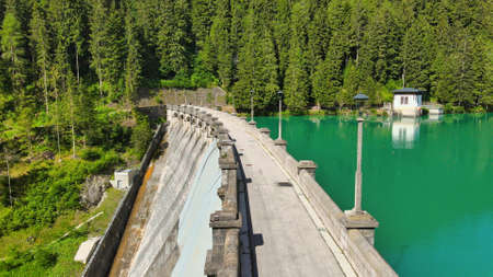 Alpin lake and dam in summertime, view from drone, Auronzo, italian dolomites.の写真素材