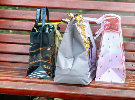 Colorful gift boxes on a red bench. Sale concept.の写真素材