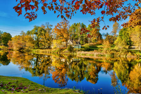 Amazing foliage reflections on a lake. Autumn in New England, USA.の写真素材
