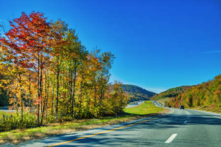 Beautiful road of New England in foliage season, USA.の写真素材