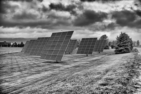 Solar panels at sunrise with cloudy sky in the countryside. Solar energy, modern electric power production technology, renewable energy concept. Environmentally friendly electricity production.の写真素材