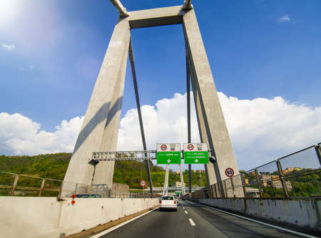 Morandi Bridge in Genova, Italy. Car traffic on a beautiful day, view from a moving carの写真素材
