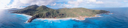 Aerial view of tropical island with sea, vegetation and shoreline.の写真素材