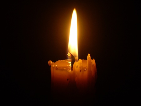 burning candle on a black backgroundの写真素材