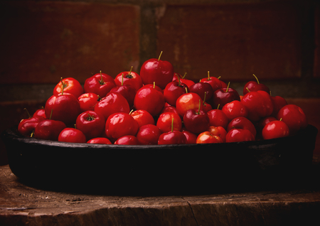 Acerola Red - tropical fruits in bowlの写真素材
