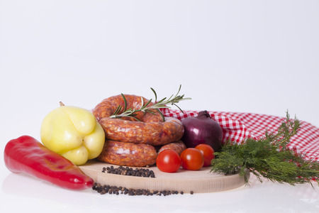 raw homemade sausages with vegetable and spices on the tableの写真素材