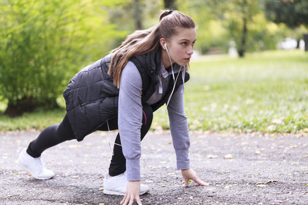 Beautiful young woman running in the park, Selective focus and small depth of field, lens flareの写真素材